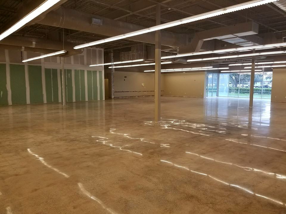 Image of polished industrial concrete floors with a glossy, reflective surface and intricate patterns, creating a sleek and modern look for the industrial space.